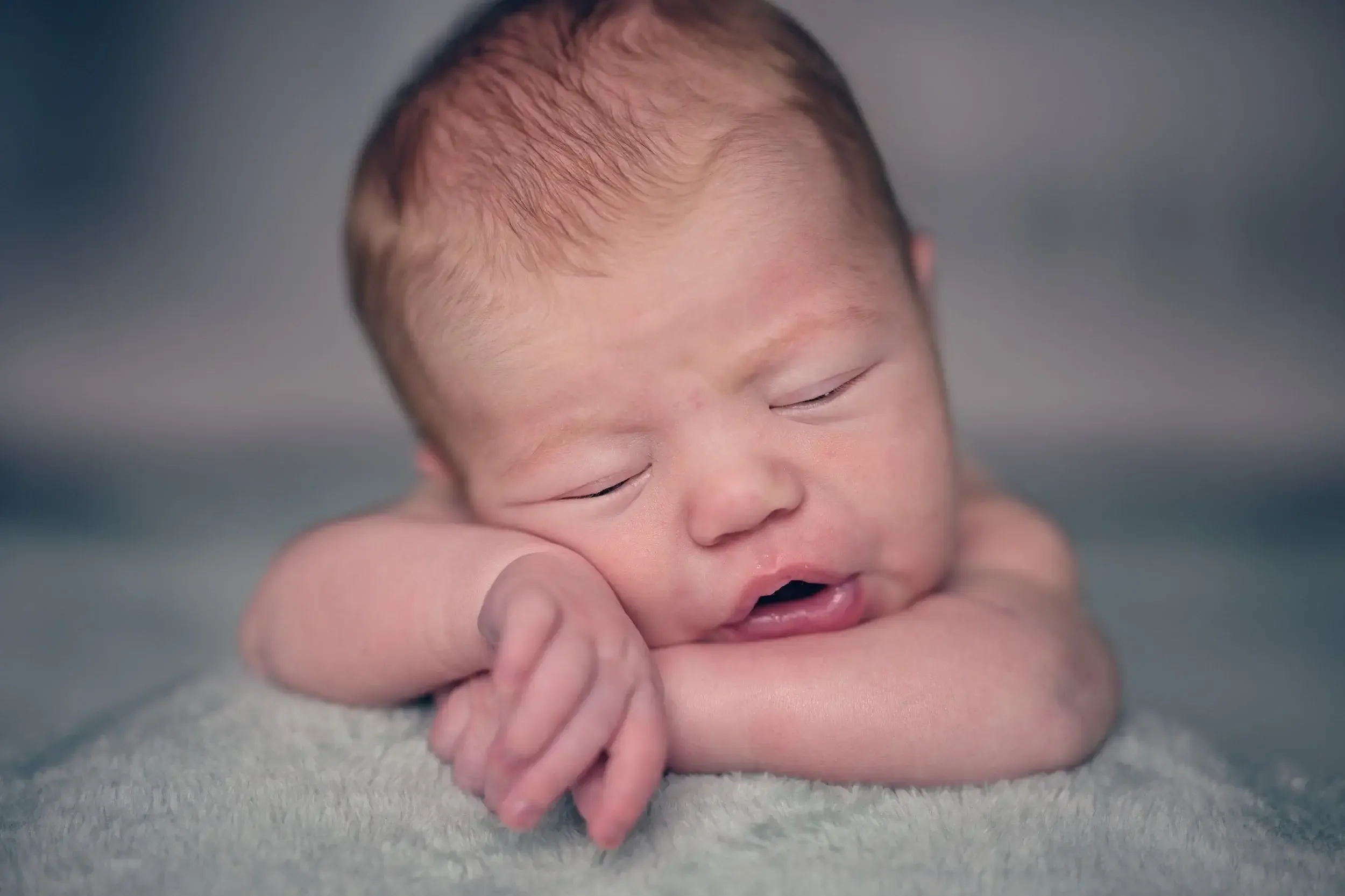 Een close-up van een slapende baby is een populaire en veelgevraagde newborn foto. Je krijgt dit prachtige resultaat alleen voor elkaar wanneer de kleine goed en stevig slaapt, zodat je het schattige en vreedzame moment optimaal kunt vastleggen.